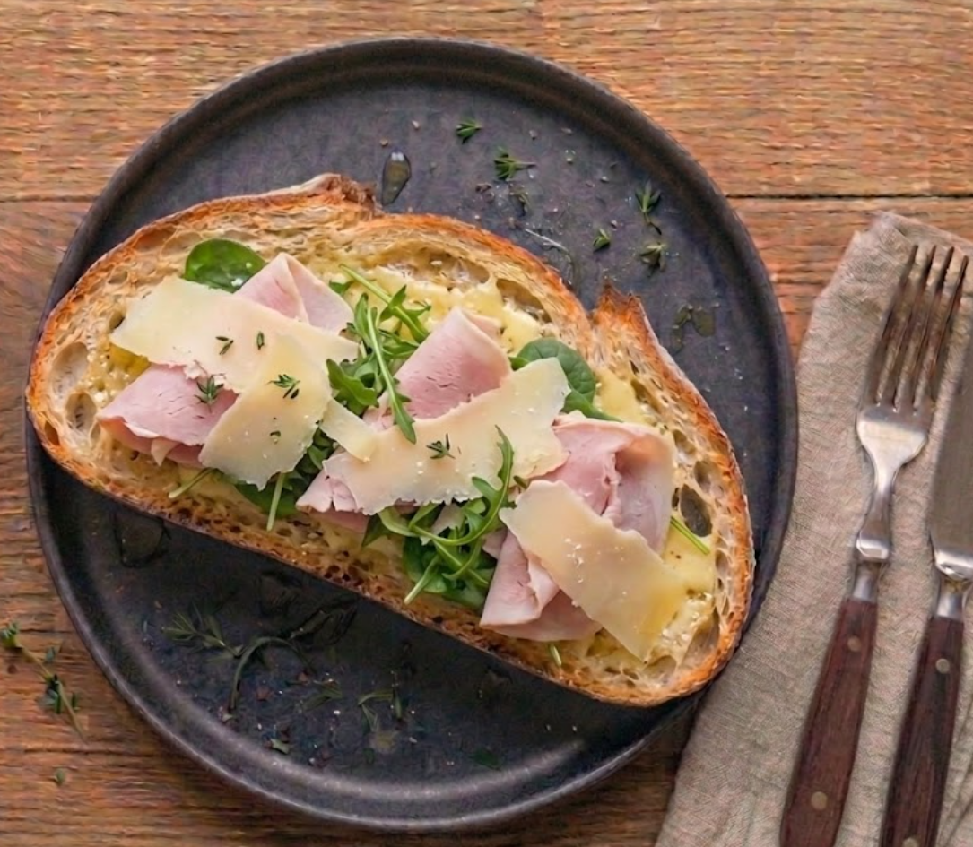 Tartine La Rémy — pain de campagne, beurre demi-sel, fines tranches de jambon blanc, copeaux de comté affiné 24/48 mois, roquette, thym frais.